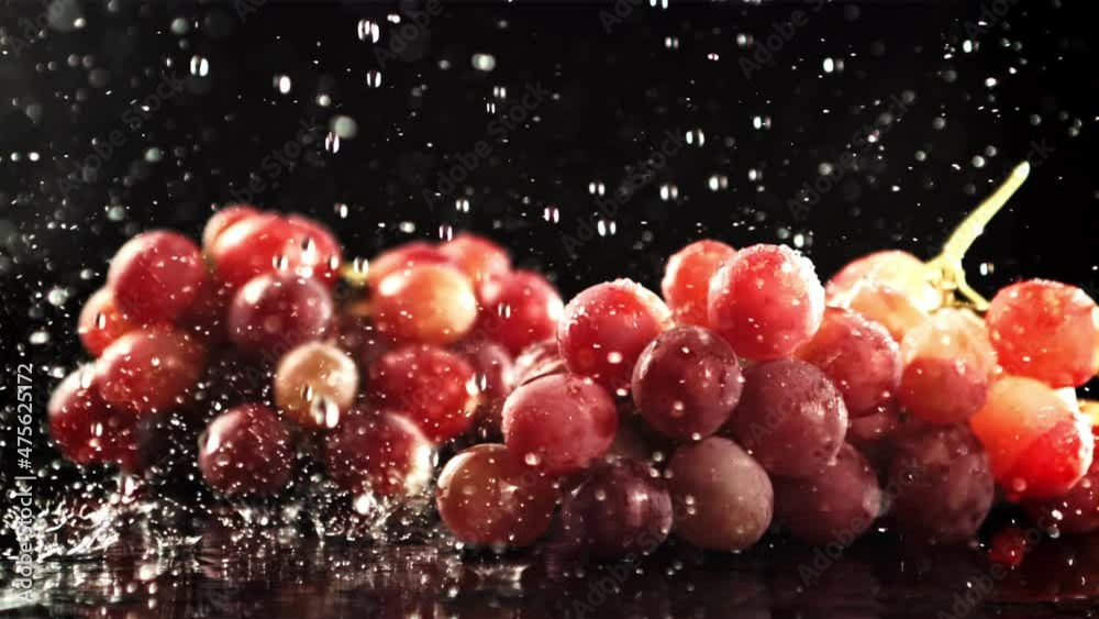 Drops of water fall on fresh grapes. On a black background. Filmed is slow motion 1000 fps. High quality FullHD footage Drops of water fall on fresh grapes. On a black background. Filmed is slow motion 1000 fps. High quality FullHD footage