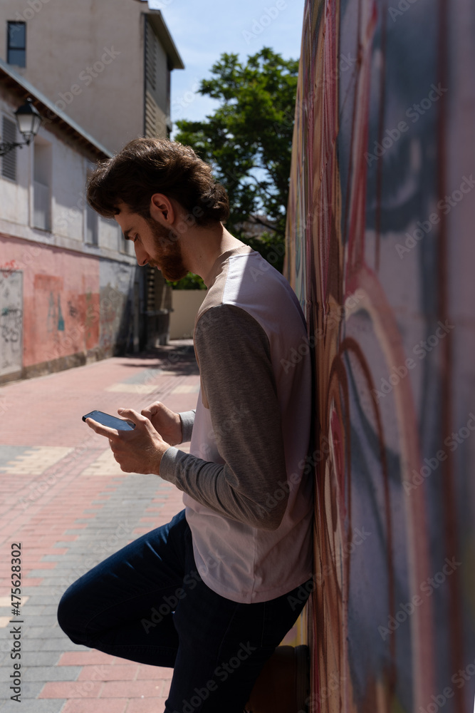Adult writes a message with his smartphone