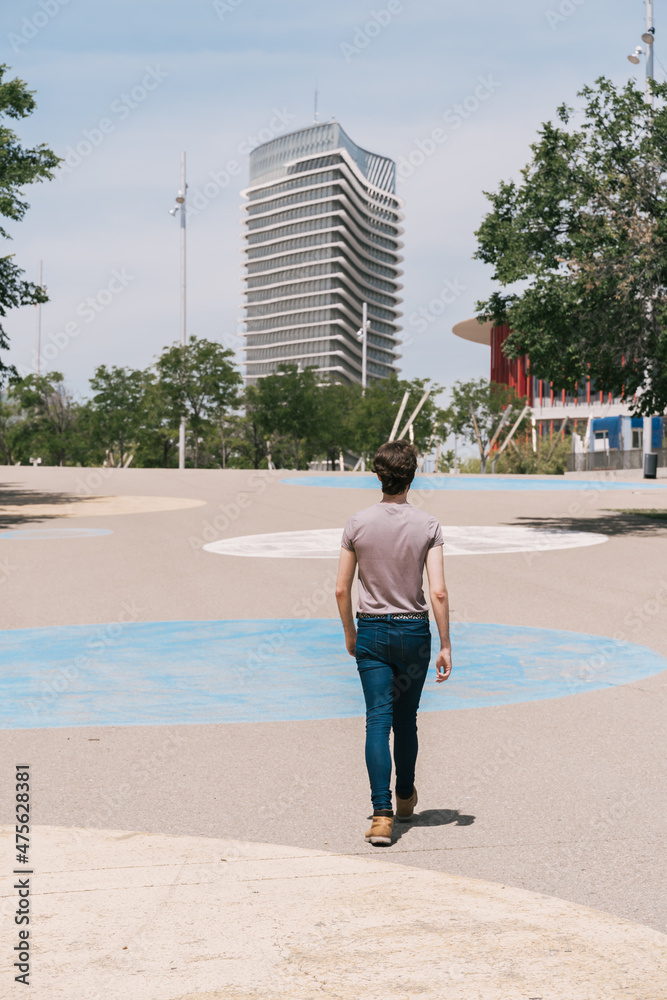 boy walking through built-up area