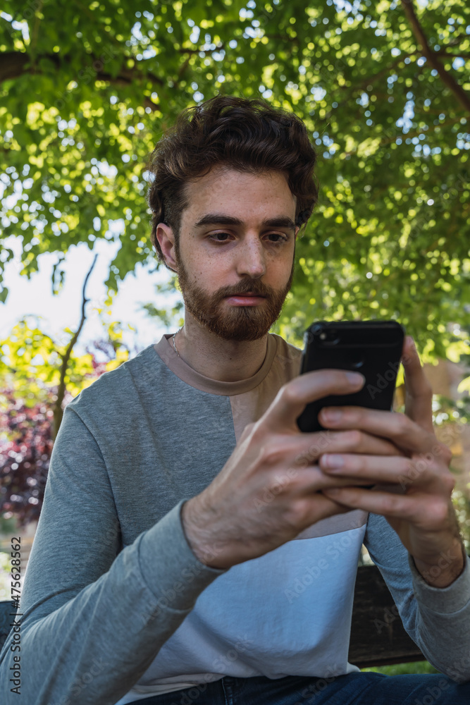 Young boy typing on his smartphone