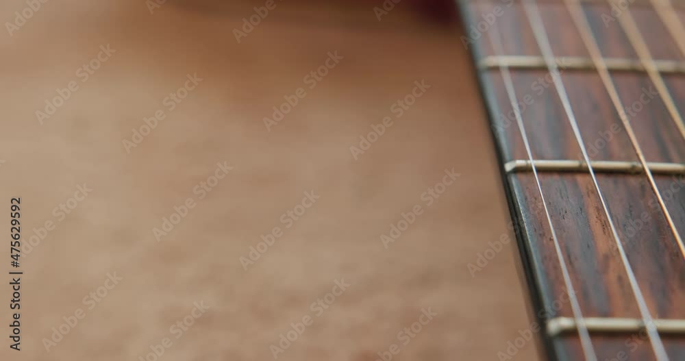 Close-up. Acoustic guitar with very shallow depth of field, emphasis on strings. Prores HQ 422, High quality. Close-up. Acoustic guitar with very shallow depth of field, emphasis on strings. Prores HQ 422, High quality.