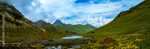 Panorama of the mountains. Scenic green meadow landscape in the Himalayas. Great Lake Trek in Kashmir, India. Mountains in Gangabal Lake vicinity. 