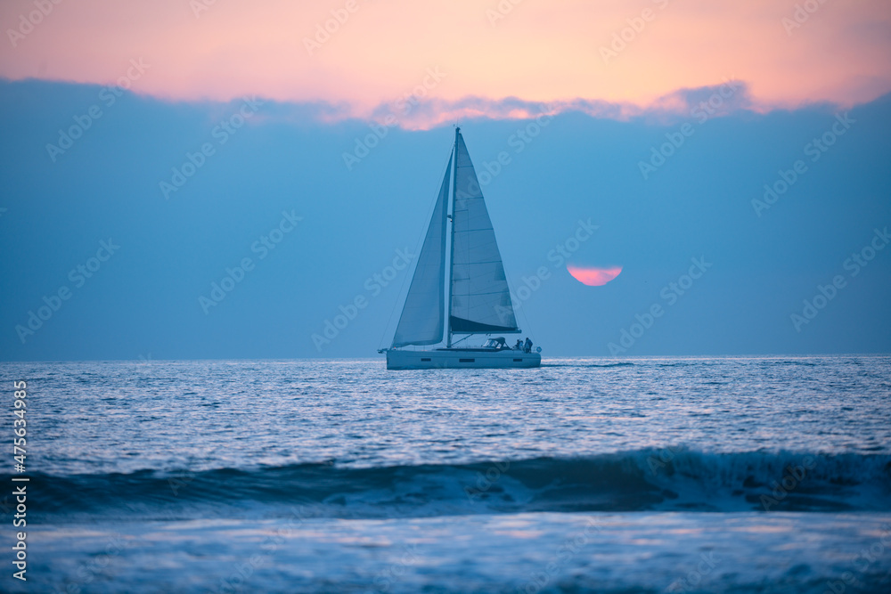 Sailing in the sunrise time with sailboat.