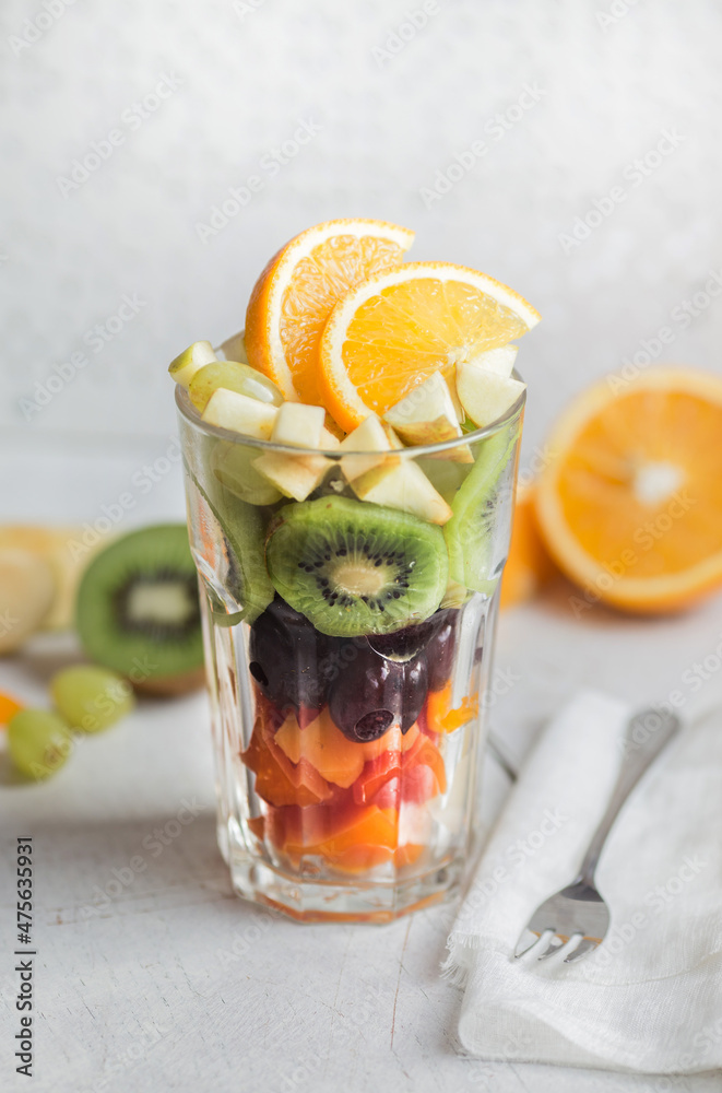 Fototapeta premium Fresh fruit salad in a tall glass