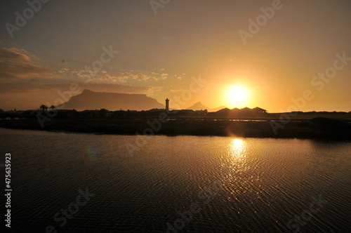 Table Mountain Panoramic Landscape with Beautiful Colorful Sunset and Streaking Clouds Landscape, Cape Town, South Africa. Sunset over the river.  © halitomercamci