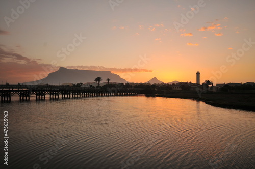 Table Mountain Panoramic Landscape with Beautiful Colorful Sunset and Streaking Clouds Landscape, Cape Town, South Africa. Sunset over the river.  © halitomercamci