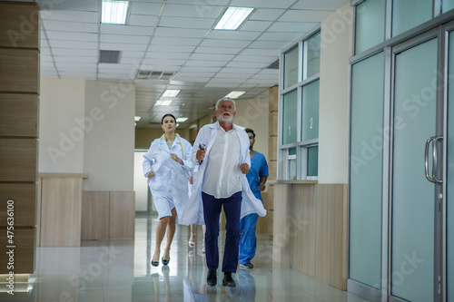 group of diverse doctor team running in hospital corridor during emergency