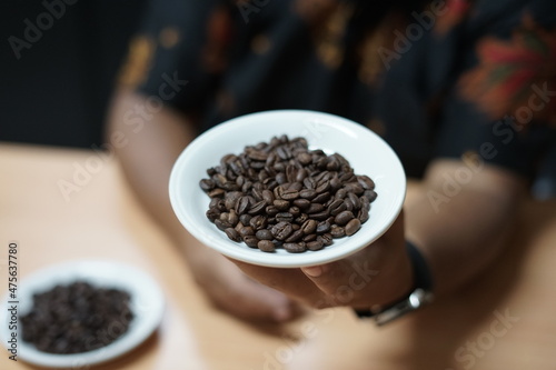 a plate Arabica coffee roasted beans that are ready to be grinded 