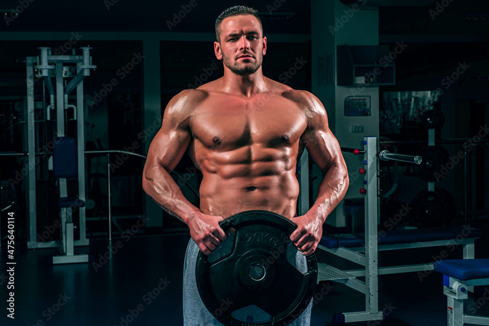 Man in gym. Power, strength and healthy lifestyle, sport. Powerful attractive muscular man trainer do workout at the gym. Man in gym. Power, strength and healthy lifestyle, sport. Powerful attractive muscular man trainer do workout at the gym.