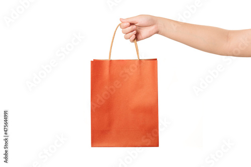 Hand holding shopping bag isolated on white