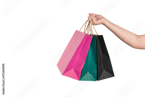 Female hand holding shopping bags isolated