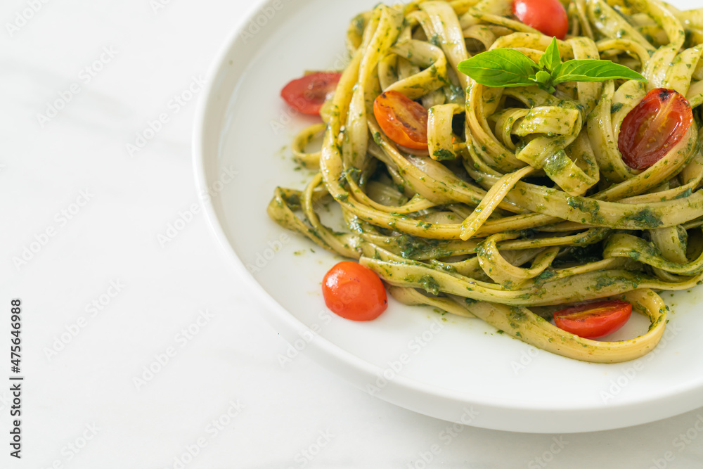 fettuccine spaghetti pasta with pesto sauce and tomatoes fettuccine spaghetti pasta with pesto sauce and tomatoes