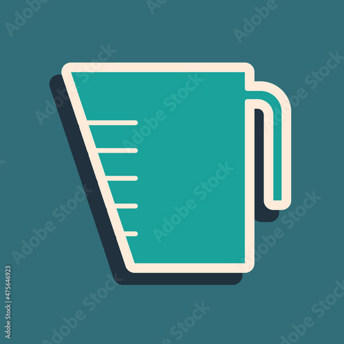 Green Measuring cup to measure dry and liquid food icon isolated on green background. Plastic graduated beaker with handle. Long shadow style. Vector Illustration