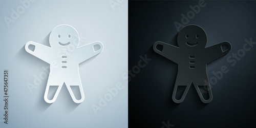 Paper cut Holiday gingerbread man cookie icon isolated on grey and black background. Cookie in shape of man with icing. Paper art style. Vector