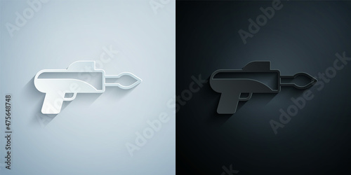 Paper cut Fishing harpoon icon isolated on grey and black background. Fishery manufacturers for catching fish under water. Diving underwater equipment. Paper art style. Vector