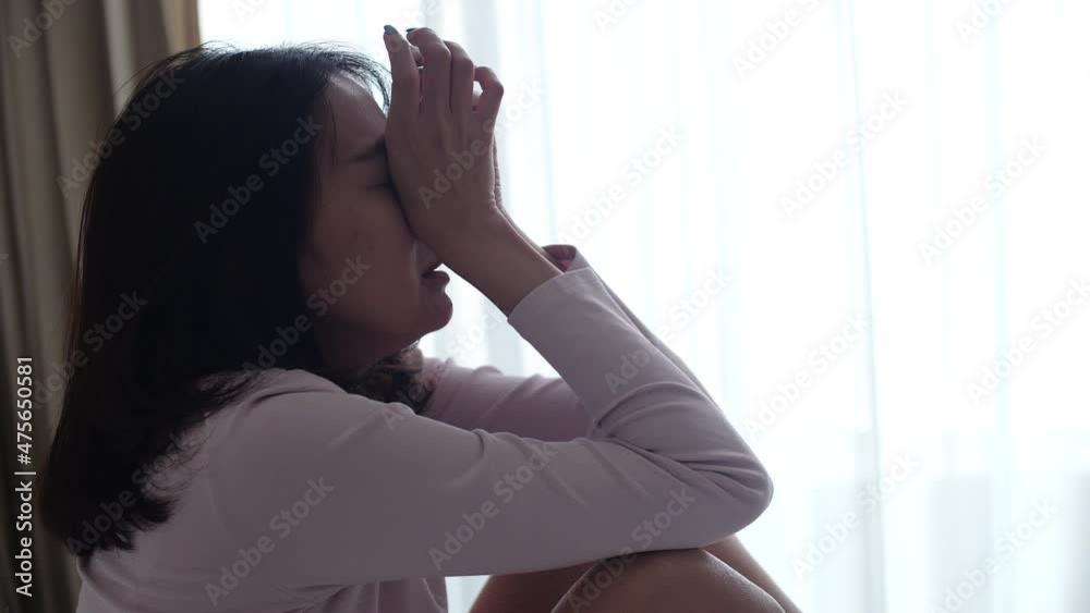 A woman is anxiety and crying in the bedroom.
A woman is anxiety and crying in the bedroom.