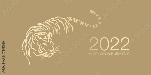Happy Chinese New Year 2022 by gold brush stroke abstract paint of the tiger isolated on golden background.