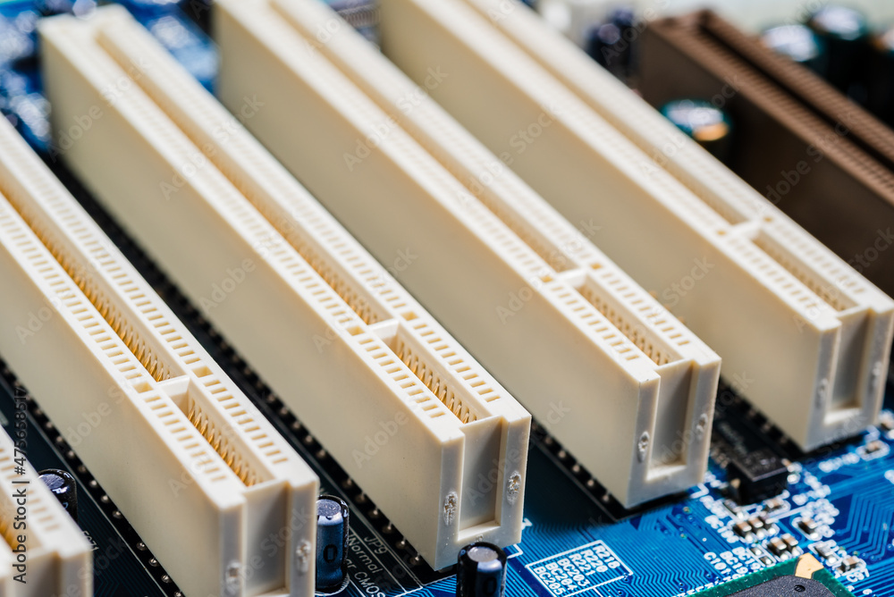 Fragment of a computer motherboard with attachment points for additional electronic components, close-up Fragment of a computer motherboard with attachment points for additional electronic components, close-up