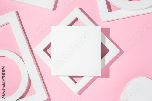 White presentation podiums geometric shapes on a pink background. Top view, flat lay