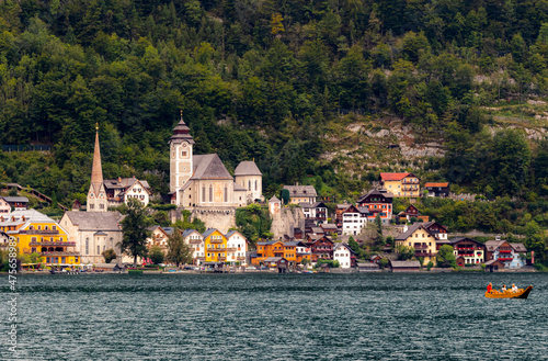 view of a village with church and beautiful buildings, beautiful landscapes with mountains and clouds , pictures  of Hallstatt city in Austria 