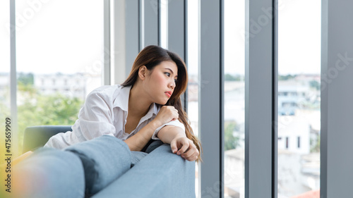 Asian young female teenager model in casual outfit sitting on cozy sofa couch with pillows wearing headphones listening to music changing track song playlist from smartphone in living room at home Free Download Asian young female teenager model in casual outfit sitting on cozy sofa couch with pillows wearing headphones listening to music changing track song playlist from smartphone in living room at home - GFXLoad