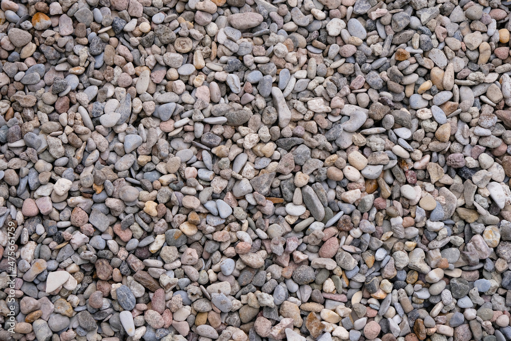 Colored small pebbles of gray, pink, and beige color for design. Colored small pebbles of gray, pink, and beige color for design.