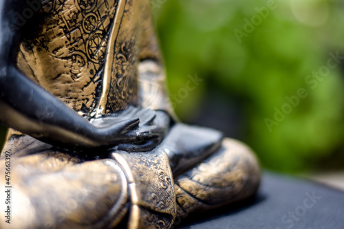 Fotografie Closeup of the statue of Buddha against the background of the garden