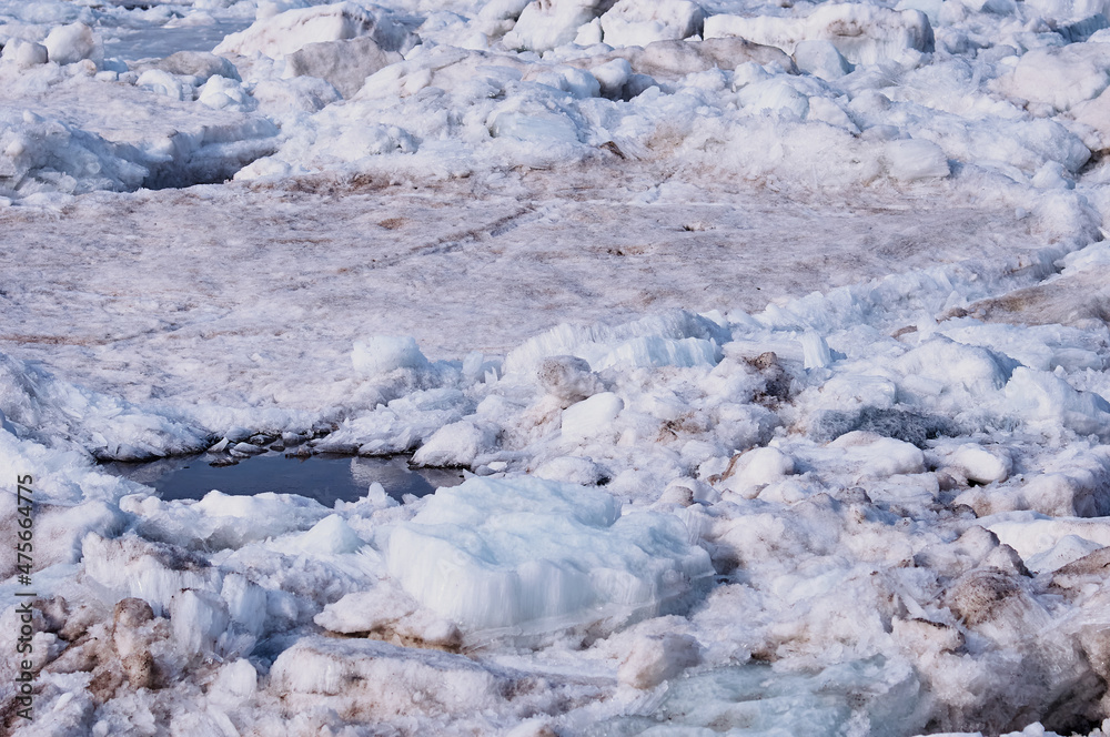 Thawed patches on ice. Melting river ice. Columnar and needle-like structure of crystals. Thawed patches on ice. Melting river ice. Columnar and needle-like structure of crystals.
