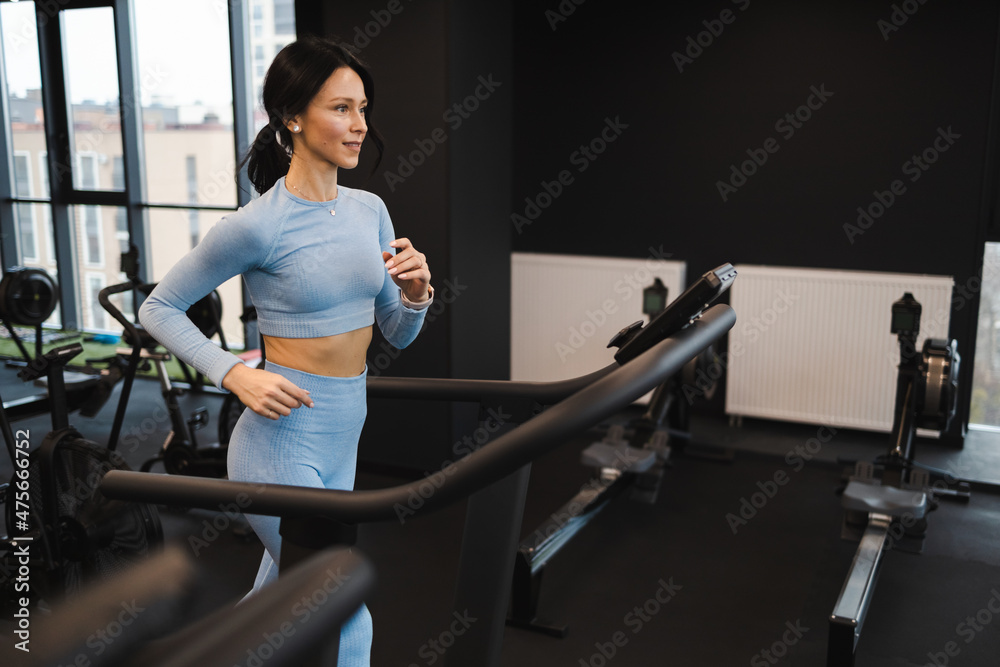 Pretty caucasian woman working out on a treadmill Pretty caucasian woman working out on a treadmill