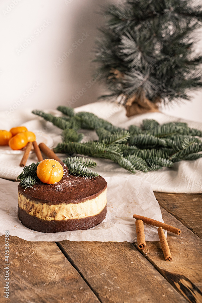 new year's tangerine cake on a wooden table with spruce branches and cinnamon new year's tangerine cake on a wooden table with spruce branches and cinnamon