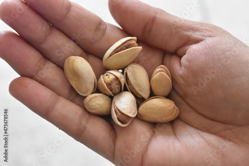 pistachios in hand on a white background