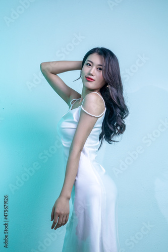 An elegant and dignified woman in a white dress
