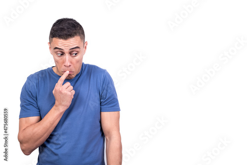 Man with finger in mouth and expression of doubt