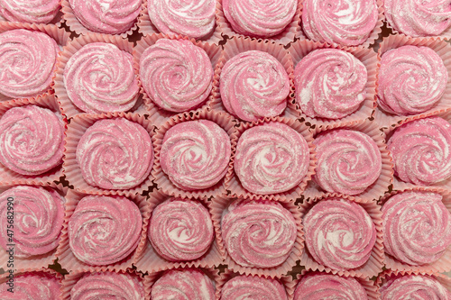 Pink cupcakes in rows, sweet dessert background.