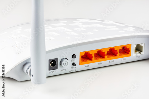 connectors, control buttons. lan and adsl ports on a new white Wi Fi router with gray antennas on a white background close-up