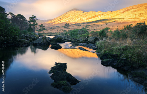Beautiful sunrise landscape scenery of mountain reflected in Erriff River at Aesleagh, county Mayo, Ireland  photo