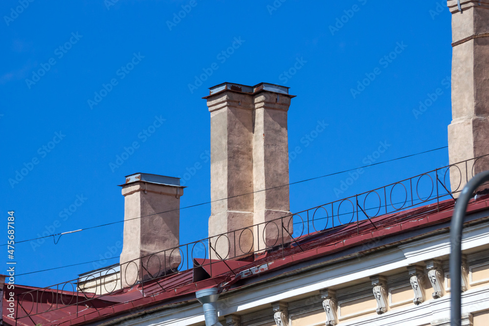Chimneys on old buildings in St. Petersburg. Heating systems with coal and wood.