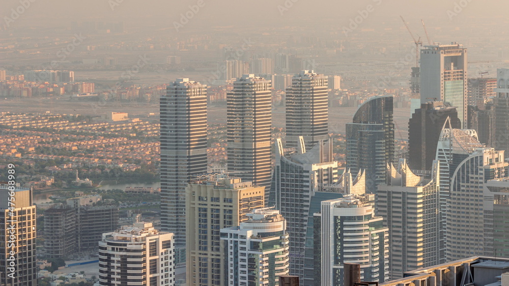 Jumeirah Lakes Towers district with many skyscrapers along Sheikh Zayed Road aerial timelapse.