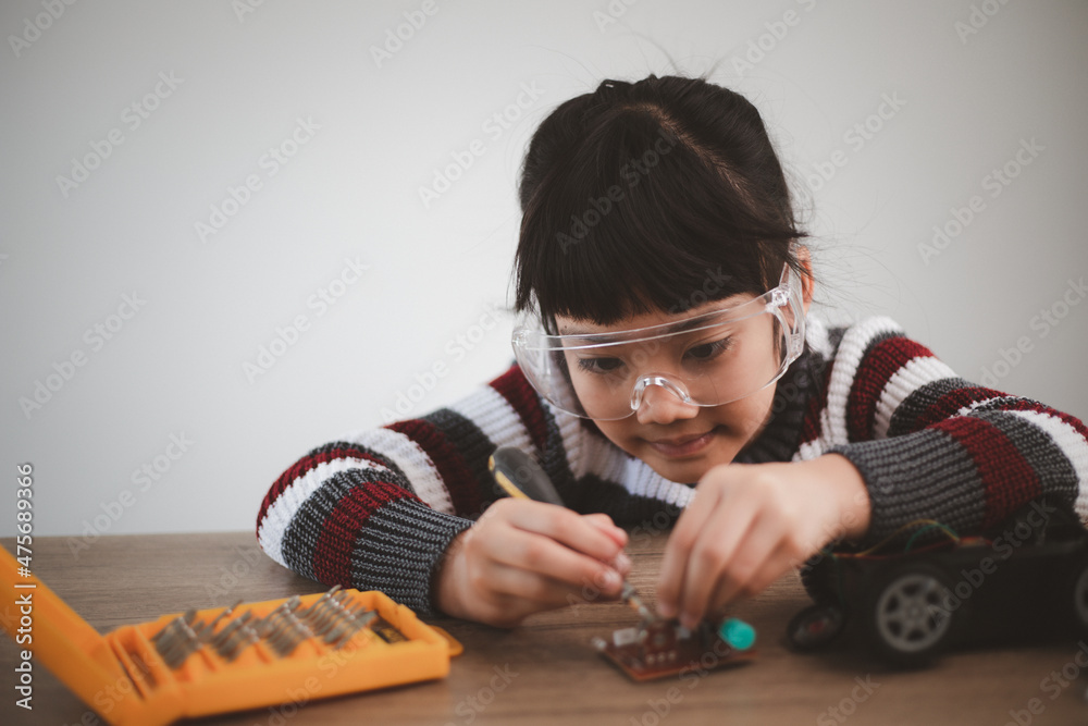 Little girls having fun in a workshop coding robot car Little girls having fun in a workshop coding robot car