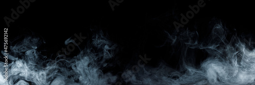 Panoramic view of the abstract fog. White cloudiness, mist or smog moves on black background. Beautiful swirling gray smoke. Mockup for your logo. Wide angle horizontal wallpaper or web banner.