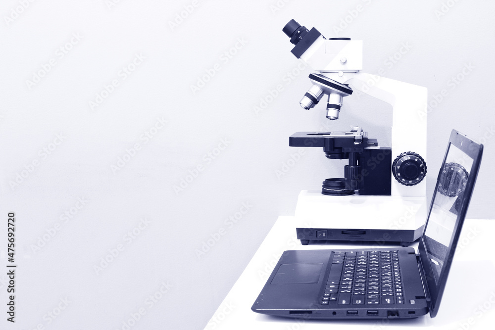 Microscope and Laptop on the Table in Laboratory Room Microscope and Laptop on the Table in Laboratory Room