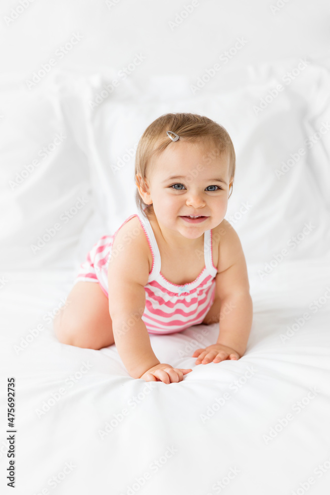 cute chubby baby girl crawling on white bed cute chubby baby girl crawling on white bed