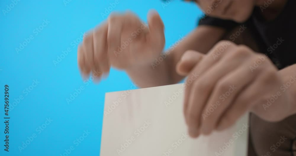 Close up of male hands collecting bookshelf. High quality. Close up of male hands collecting bookshelf. High quality.