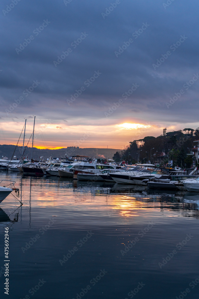 view of sailboats and yachts moored in the marina of  Istanbul, Turkey. Sunrise with colorful clouds and sky