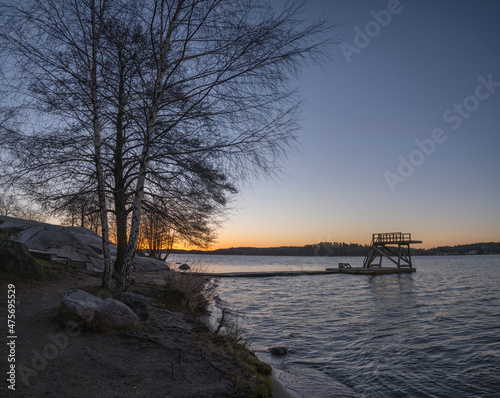 Morning view at sunrise, jump tower, silhouettes and reflections at the lake Mälaren in the district Bromma a sunny day in Stockholm © Hans Baath