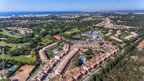 Aerial drone footage of a Portuguese tourist village overlooking the sea and golf courses. Vila Sol