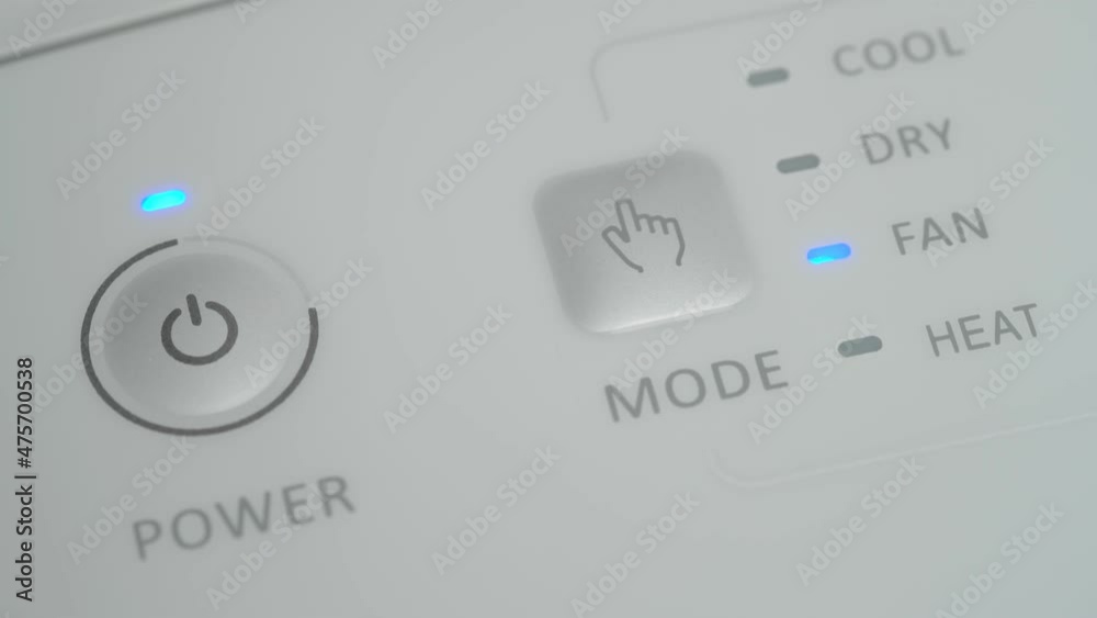 The person presses the start button on the mobile air conditioner with his finger to ventilate the room. Close-up. The person presses the start button on the mobile air conditioner with his finger to ventilate the room. Close-up.
