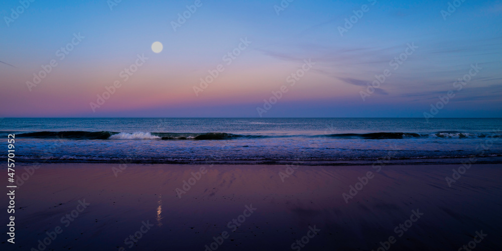 Obraz premium Moonrise seascape and wet sand reflections at Cape Cod National Seashore, 40 miles long pristine sandy beach, hills, and trails.
