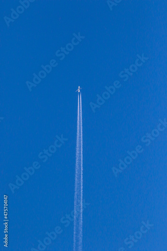 plane flying on a clear blue sky