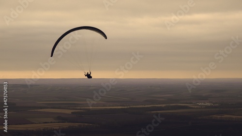 Paragliding above the landscape during the sunrise near Mikulov, Czech republic